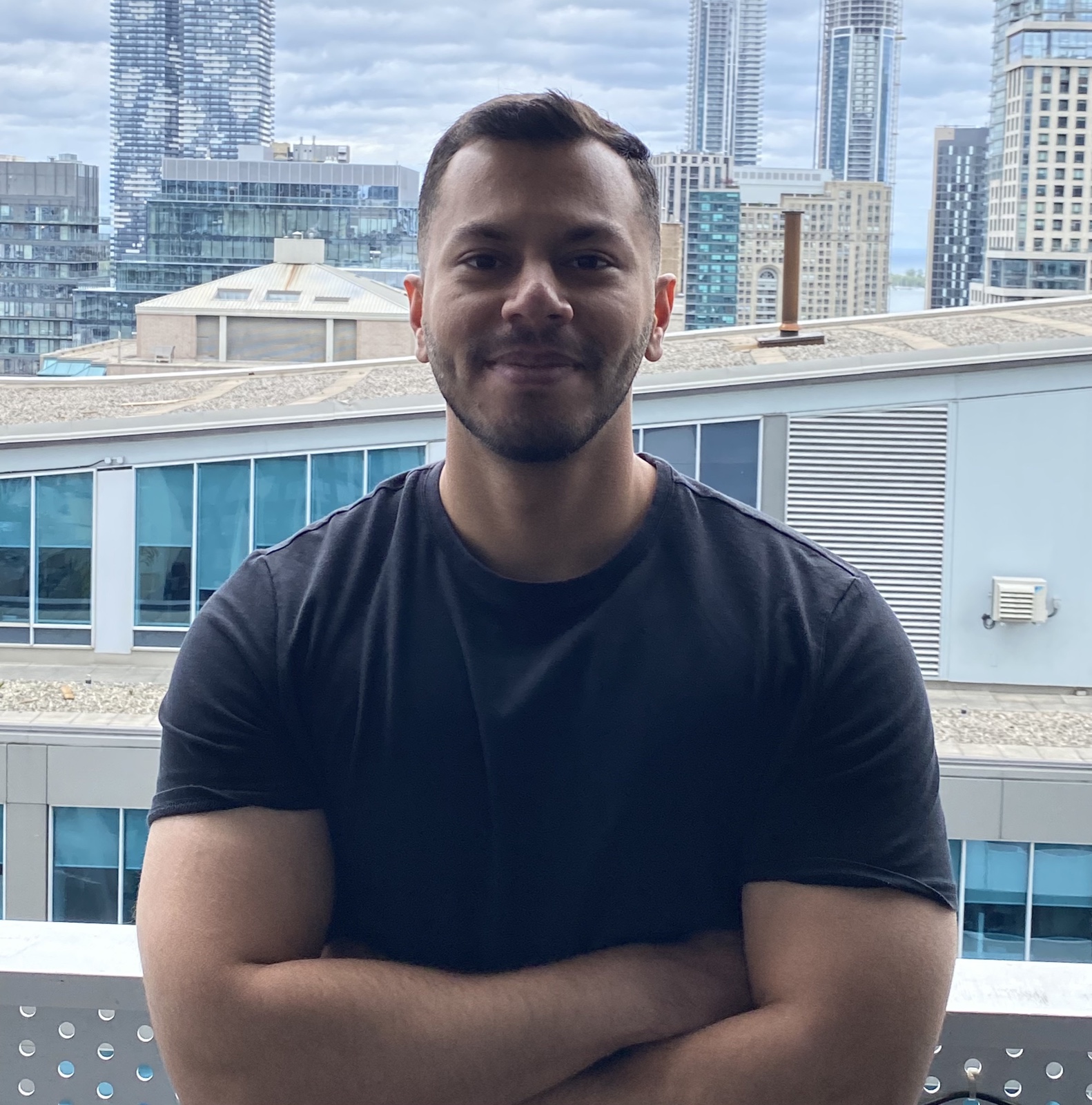 Raghav Kalra standing in front of the Toronto skyline